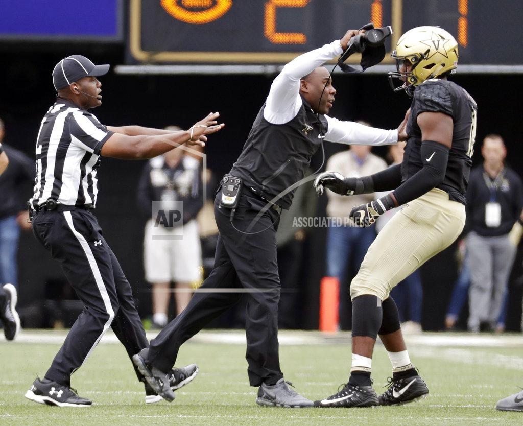 Mark Humphrey Vanderbilt head coach Derek Mason, center, pushes defensive lineman Dayo Odeyingbo (10) off the field during a confrontation between Vanderbilt and Florida in the first half of an NCAA college football game Saturday, Oct. 13, 2018, in Nashville, Tenn. (AP Photo/Mark Humphrey)