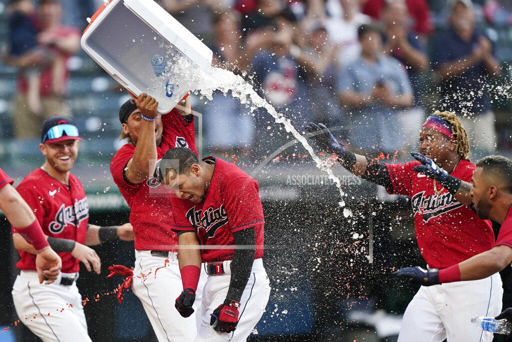 Tony Dejak Cleveland Indians teammates douse Cesar Hernandez, center, after he hit the winning two-run home run in the 10th inning of a baseball game against the Minnesota Twins, Saturday, May 22, 2021, in Cleveland. (AP Photo/Tony Dejak)
