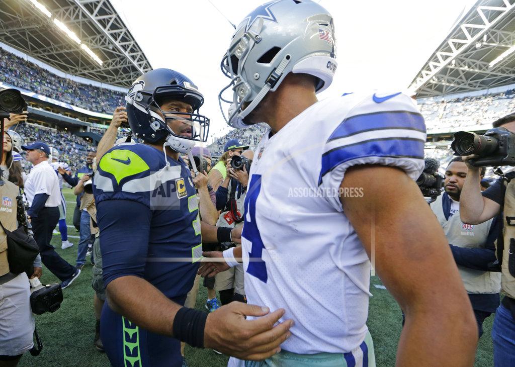 John Froschauer FILE - In this Sept. 23, 2018, file photo, Seattle Seahawks quarterback Russell Wilson, left, greets Dallas Cowboys quarterback Dak Prescott, right, following an NFL football game in Seattle. Russell Wilson won a playoff game with Seattle as a rookie, a Super Bowl in his second season and another NFC championship the third time around. The best Dak Prescott can hope for with the Dallas Cowboys is to join Wilson on that list of Super Bowl winners in his third year, a quest that will start with the first postseason meeting of quarterbacks with quite a bit in common, other than postseason pedigree.(AP Photo/John Froschauer, File)