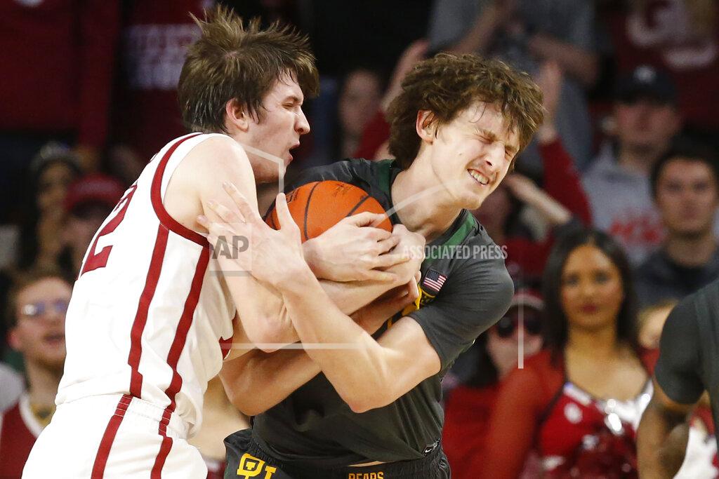 Sue Ogrocki Oklahoma guard Austin Reaves, left, and Baylor guard Matthew Mayer fight for control of the ball during the first half of an NCAA college basketball game in Norman, Okla., Tuesday, Feb. 18, 2020. (AP Photo/Sue Ogrocki)