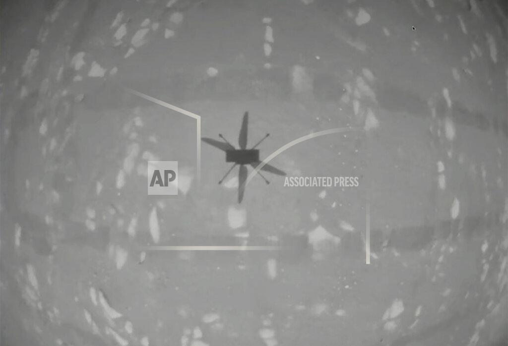 Uncredited In this image from NASA, NASA's experimental Mars helicopter Ingenuity hovers above the surface of Mars Monday, April 19, 2021. The little 4-pound helicopter rose from the dusty red surface into the thin Martian air Monday, achieving the first powered, controlled flight on another planet. (NASA via AP)