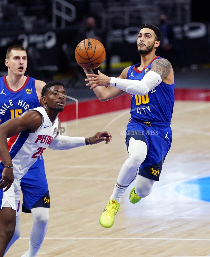 Carlos Osorio Denver Nuggets guard Markus Howard (00) makes a layup next to Detroit Pistons forward Tyler Cook (25) during the first half of an NBA basketball game, Friday, May 14, 2021, in Detroit. (AP Photo/Carlos Osorio)