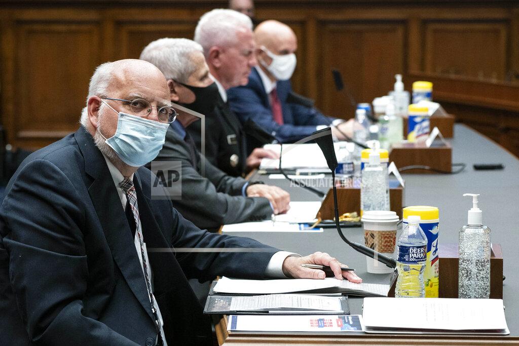 Sarah Silbiger FILE - In this Tuesday, June 23, 2020 file photo, Dr. Robert Redfield, director of the Centers for Disease Control and Prevention, left, listens during a House Committee on Energy and Commerce on the Trump administration's response to the COVID-19 pandemic on Capitol Hill in Washington. On Friday, July 17, 2020, The Associated Press reported on a photo circulating online incorrectly asserting it shows a CDC report with many claims about face masks, including that cloth masks trap exhaled carbon dioxide and collect mildew within 30 minutes, risking your health. The document in the photo is fake and falsely attributed to the CDC, the agency told The Associated Press. (Sarah Silbiger/Pool via AP)