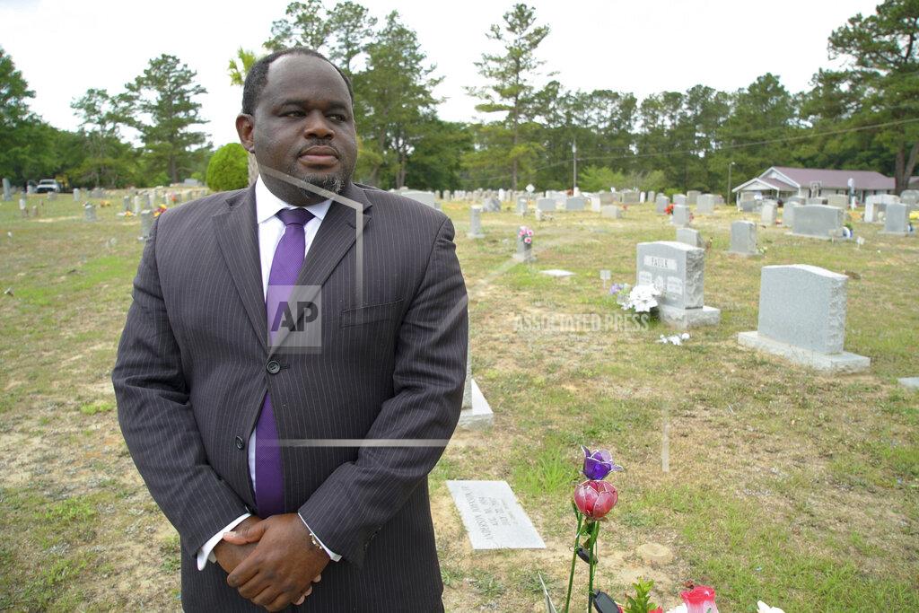 Allen G. Breed Funeral director Shawn Troy stands for a portrait at Hillcrest Cemetery outside Mullins, S.C., on Monday, May 24, 2021. His father, William Penn Troy Sr., who developed the cemetery and is buried there, died of COVID-19 in August 2020, one of many Black funeral directors to succumb during the pandemic. (AP Photo/Allen G. Breed)