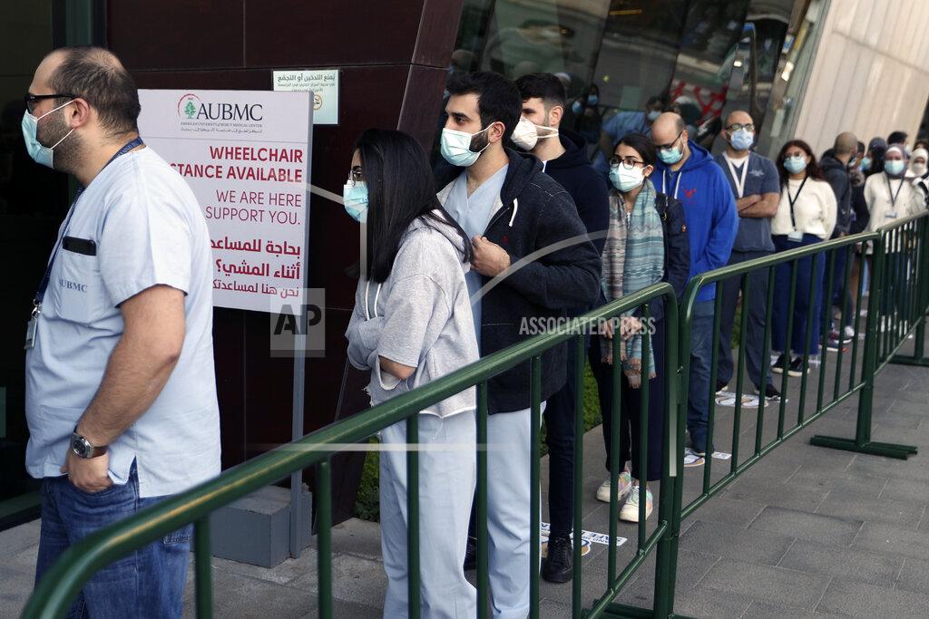 Bilal Hussein Frontline medical workers stand in line to get the Pfizer-BioNTech COVID-19 vaccine during a nationwide vaccination program at the American University Medical Center in Beirut, Lebanon, Sunday, Feb. 14, 2021. (AP Photo/Bilal Hussein)