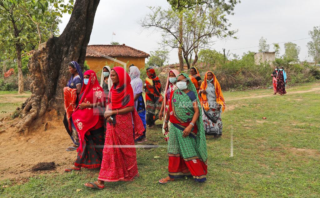 Rajesh Kumar Singh Women return to their village after attending an awareness program on getting tested and vaccinated against COVID-19 in Jamsoti village, Uttar Pradesh state, India, on June 10, 2021. India's vaccination efforts are being undermined by widespread hesitancy and fear of the jabs, fueled by misinformation and mistrust. That's especially true in rural India, where two-thirds of the country’s nearly 1.4 billion people live. (AP Photo/Rajesh Kumar Singh)