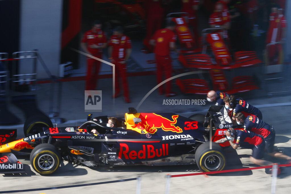 Mechanics push the car of Red Bull driver Max Verstappen as they practice tires change at the Red Bull Ring racetrack in Spielberg, Austria, Thursday, July 9, 2020. Styrian Formula One Grand Prix will be held on Sunday. (AP photo/Darko Bandic)