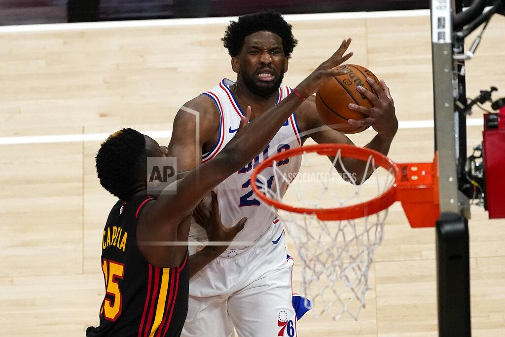 John Bazemore Philadelphia 76ers center Joel Embiid (21) goes up to shoot as Atlanta Hawks center Clint Capela (15) defunds during the first half of an NBA basketball game Monday, Jan. 11, 2021, in Atlanta. (AP Photo/John Bazemore)