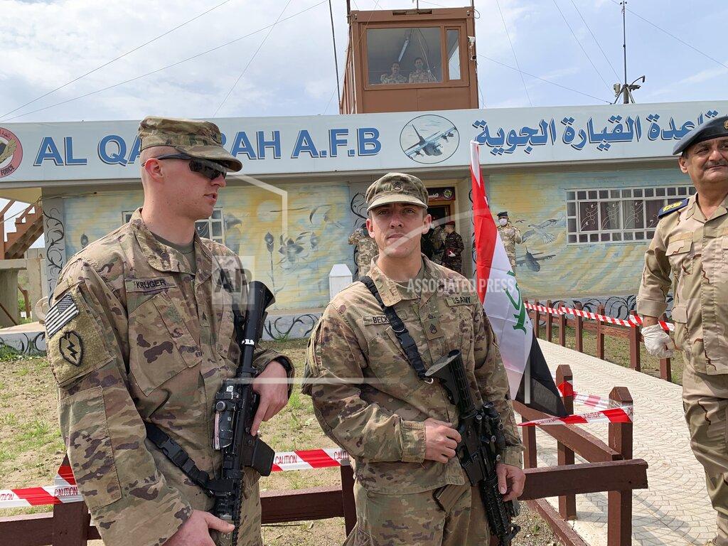 Ali Abdul Hassan FILE - In this March 27, 2020 file photo, U.S. soldiers stand guard during the hand over ceremony of Qayyarah Airfield, Iraqi Security Forces, in the south of Mosul, Iraq. In a quest to root out Islamic State group hideouts over the summer, Iraqi forces on the ground cleared nearly 90 villages across a notoriously unruly northern province. But the much-touted operation still relied heavily on U.S. intelligence, coalition flights and planning assistance. (AP Photo/Ali Abdul Hassan, File)