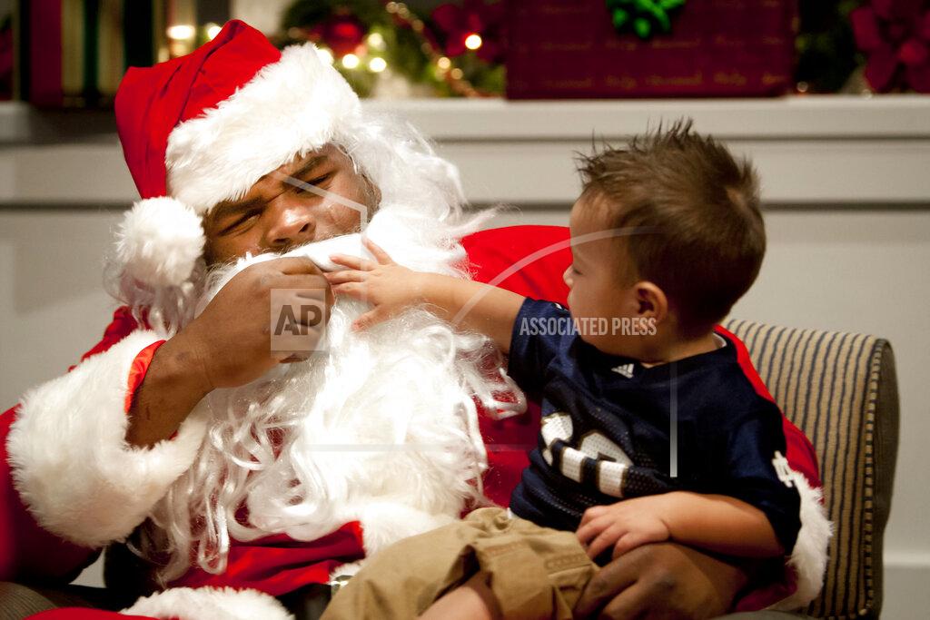 James Brosher FILE - In this Thursday, Nov. 29, 2012, file photo, Gabreal Rico, 1, takes a tug at Louis Nix III's beard as the Notre Dame football nose guard plays the part of Santa Claus during Silent Night Silent Auction, an annual fundraiser held by Notre Dame's Pasquerilla East dormitory benefiting the American Cancer Society's Relay for Life at Notre Dame's LaFortune Student Center in South Bend, Ind. Nix’s mother, Stephanie Wingfield, says authorities told her that her son had died but they were unable to give her more information about his death. The Jacksonville Sheriff’s Office said in a tweet Saturday, Feb. 27, 2021, that Nix was located, but didn’t give any other details. (James Brosher/South Bend Tribune via AP, File)