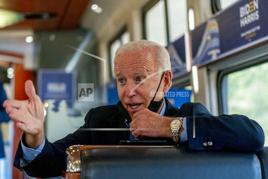 Andrew Harnik Democratic presidential candidate former Vice President Joe Biden speaks with United Steelworkers Union President Thomas Conway and school teacher Denny Flora of New Castle, Pa., aboard his train as it travels to Pittsburgh, Wednesday, Sept. 30, 2020. Biden is on a train tour through Ohio and Pennsylvania today. (AP Photo/Andrew Harnik)