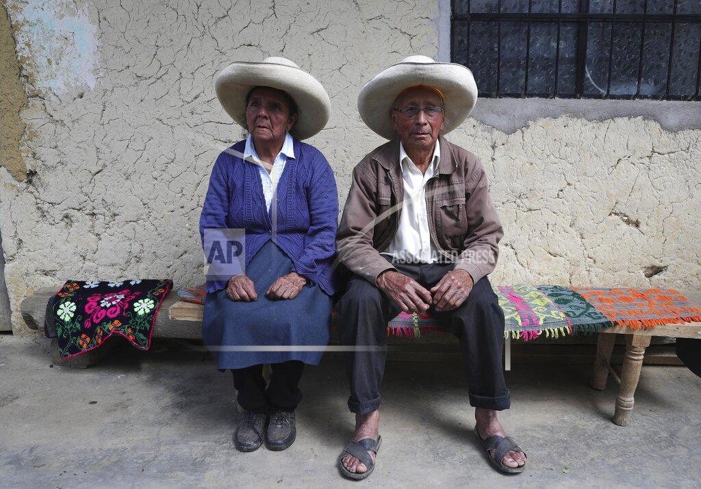 Martin Mejia Ireño Castillo and Mavila Terrones, the parents of Free Peru party presidential candidate Pedro Castillo, pose for a portrait in their home in Puna, Peru, Friday, April 16, 2021. Their son, who has proposed rewriting Peru's constitution and deporting all immigrants living in the country illegally who commit crimes, will face rival candidate Keiko Fujimori in the June 6 presidential run-off election. (AP Photo/Martin Mejia)