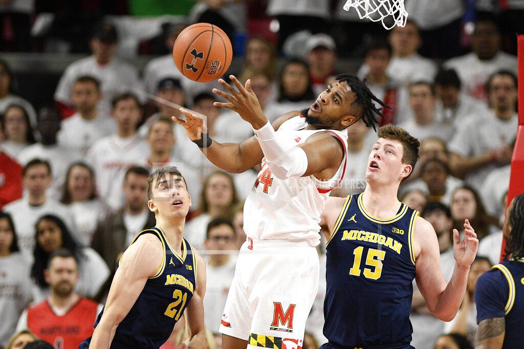 Nick Wass Maryland forward Donta Scott (24) loses the ball next to Michigan guard Franz Wagner (21) and center Jon Teske (15) during the first half of an NCAA college basketball game, Sunday, March 8, 2020, in College Park, Md. Wagner was called for a foul on the play. (AP Photo/Nick Wass)