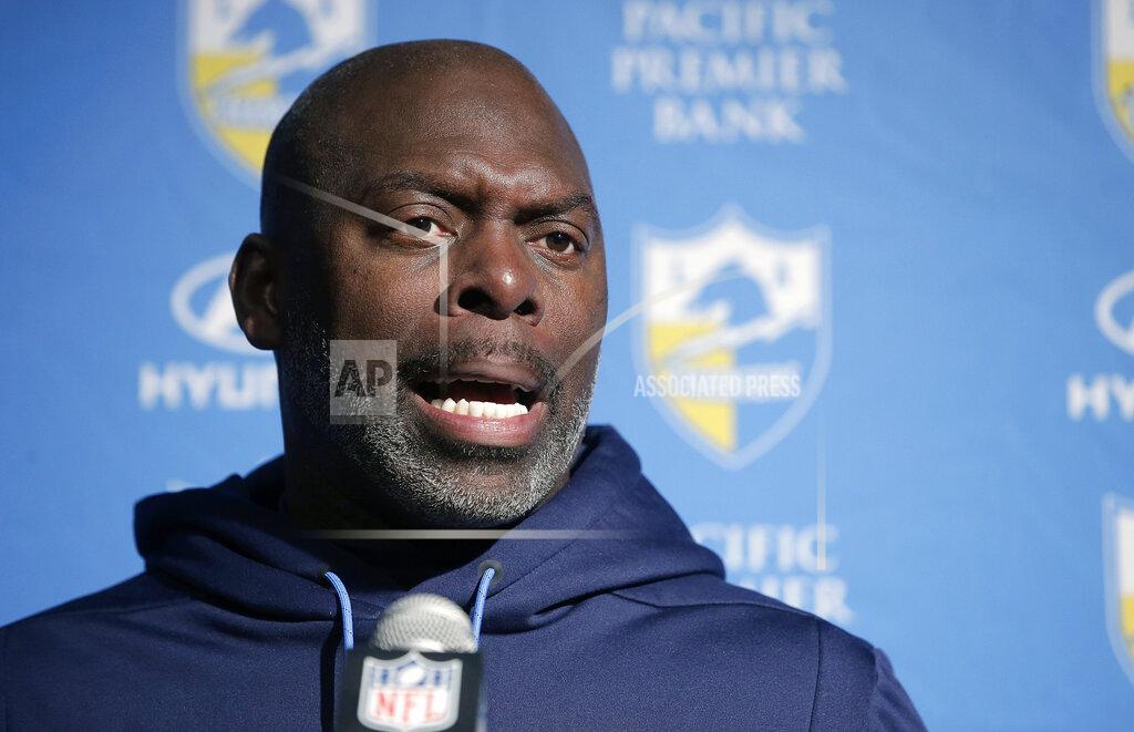 Steven Senne FILE - In this Jan. 13, 2019, file photo, Los Angeles Chargers head coach Anthony Lynn speaks to the media following an NFL divisional playoff football game against the New England Patriots, in Foxborough, Mass. Chargers coach Anthony Lynn has a busy stretch ahead before his team begins training camp in late July. He will be opening a new school in Africa, hold his own golf tournament and visit with the first responders who saved his life in 2005. (AP Photo/Steven Senne, File)