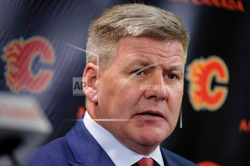 Jeff Mcintosh FILE - In this April 23, 2018, file photo, new Calgary Flames NHL hockey team head coach Bill Peters speaks to the media in Calgary, Alberta. Calgary Flames general manager Brad Treliving said the team is looking into an accusation that head coach Bill Peters directed racial slurs toward a Nigerian-born hockey player a decade ago in the minor leagues, then arranged for the player’s demotion when he complained. Akim Aliu tweeted Monday, Nov. 25, 2019, that Peters “dropped the N bomb several times towards me in the dressing room in my rookie year because he didn’t like my choice of music.” (Jeff McIntosh/The Canadian Press via AP, File)