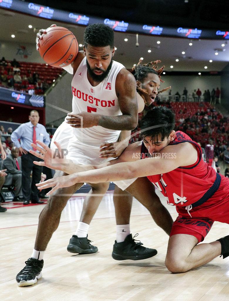 Michael Wyke Houston guard Corey Davis Jr. (5) gets control of a loose rebound over New Jersey Institute of Technology forward Mohamed Bendary (34)during the first half of an NCAA college basketball game Saturday, Dec. 29, 2018, in Houston. (AP Photo/Michael Wyke)