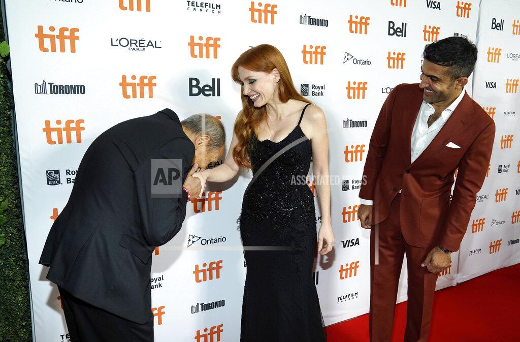 Chris Pizzello Ismael Kanater, left, a cast member in "The Forgiven," kisses the hand of cast member Jessica Chastain, center, as cast member Mourad Zaoui looks on at the premiere of the film at the 2021 Toronto International Film Festival, Saturday, Sept. 11, 2021, in Toronto. (AP Photo/Chris Pizzello)