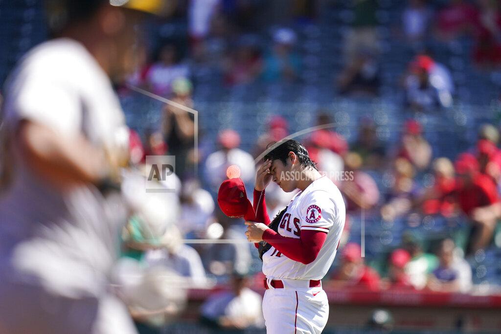 Jae C. Hong Los Angeles Angels starting pitcher Shohei Ohtani, right, of Japan, adjusts his cap after giving up a home run to Oakland Athletics' Yan Gomes, foreground, during the third inning of a baseball game Sunday, Sept. 19, 2021, in Anaheim, Calif. (AP Photo/Jae C. Hong)
