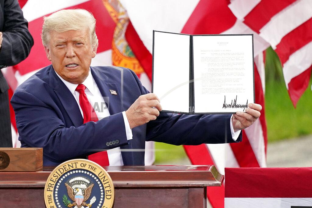 John Raoux President Donald Trump holds a signed memorandum to expand the offshore drilling moratorium to Florida's Atlantic coast, Georgia and South Carolina after speaking at the Jupiter Inlet Lighthouse and Museum Tuesday, Sept. 8, 2020, in Jupiter, Fla. (AP Photo/John Raoux)