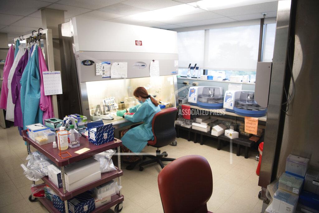 Stephanie Amador Karen Maynard, a laboratory scientist at the Tennessee public health lab, prepares COVID-19 samples for the extraction of their genetic code as part of the genome sequencing process in Nashville, Tenn., Tuesday, Sept. 14, 2021. (Stephanie Amador/The Tennessean via AP)