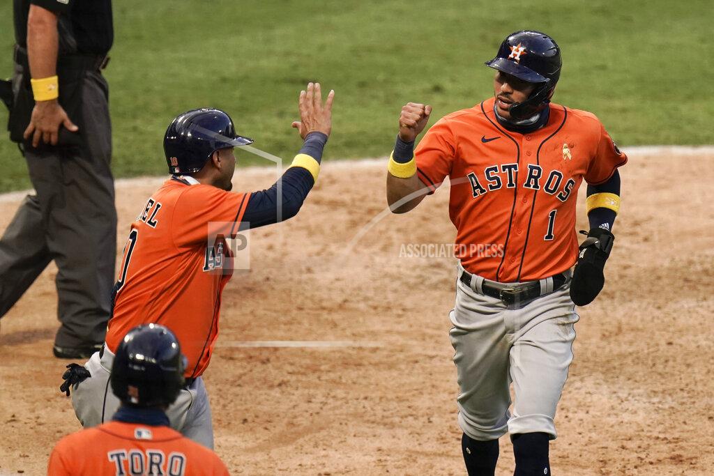 Jae C. Hong Houston Astros' Carlos Correa, right, and Yuli Gurriel celebrate after they scored on a single hit by Martin Maldonado during the seventh inning of the first baseball game of a doubleheader against the Los Angeles Angels, Saturday, Sept. 5, 2020, in Anaheim, Calif. (AP Photo/Jae C. Hong)