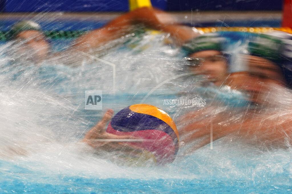 Mark Humphrey Players race for the ball at the start of a preliminary round men's water polo match between Hungary and Japan at the 2020 Summer Olympics, Tuesday, July 27, 2021, in Tokyo, Japan. (AP Photo/Mark Humphrey)