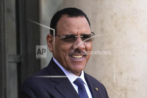 FILE - Niger's President Mohamed Bazoum smiles before a working lunch with French President Emmanuel Macron, Feb. 16, 2023 at the Elysee Palace in Paris. The Nigerien president detained since July by the soldiers who deposed him has petitioned a regional court demanding his release and reinstatement, according to court documents seen by The Associated Press on Wednesday Sept. 20, 2023. (AP Photo/Michel Euler, File)