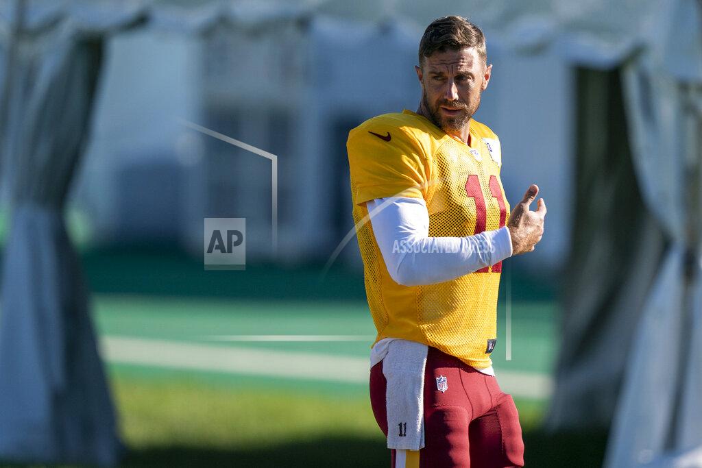 Alex Brandon Washington quarterback Alex Smith (11) walks to practice at the team's NFL football training facility, Tuesday, Aug. 18, 2020, in Ashburn, Va. (AP Photo/Alex Brandon)