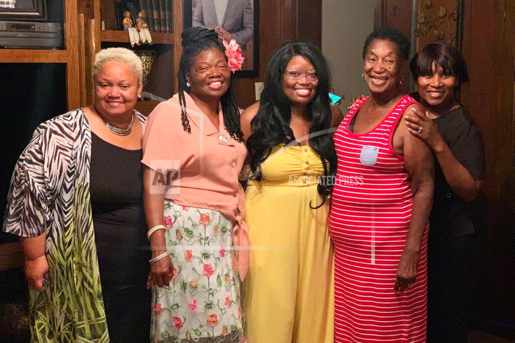 In this photo provided by Steve Morgan, Mary Louise Brown Morgan, second from right, poses with relatives in the fall of 2019. The 78-year-old grandmother died March 27, 2020, after being diagnosed with the new coronavirus. Morgan was described by family members as a “God-fearing woman,” who made a “mean gumbo and red beans,” and loved to tend to her garden of rosebushes and fruit trees. (Steve Morgan via AP)