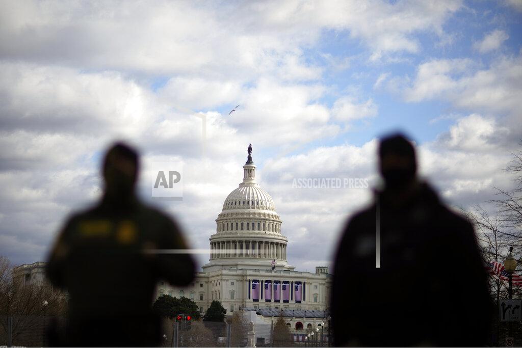 David Goldman Law enforcement stand near the Capitol ahead of the inauguration of President-elect Joe Biden and Vice President-elect Kamala Harris, Sunday, Jan. 17, 2021, in Washington. (AP Photo/David Goldman)