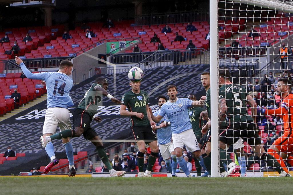 Alastair Grant Manchester City's Aymeric Laporte, left, scores the opening goal during the English League Cup final soccer match between Manchester City and Tottenham Hotspur at Wembley stadium in London, Sunday, April 25, 2021. (AP Photo/Alastair Grant)