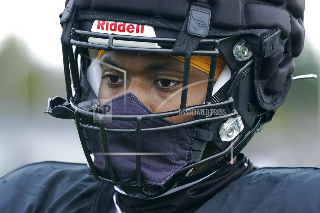 Ted S. Warren Nasier Ford, a freshman defensive lineman at Pacific Lutheran, wears a mask that is integrated into his football helmet, during practice Tuesday, Feb. 2, 2021, in Tacoma, Wash. For all the attention heaped on the FBS level of college football last fall as it tried to play, it will not be the only college football during the 2020-21 sports calendar as a handful of NCAA Division III and NAIA programs begin some form of a winter/spring season Saturday, Feb. 6. (AP Photo/Ted S. Warren)