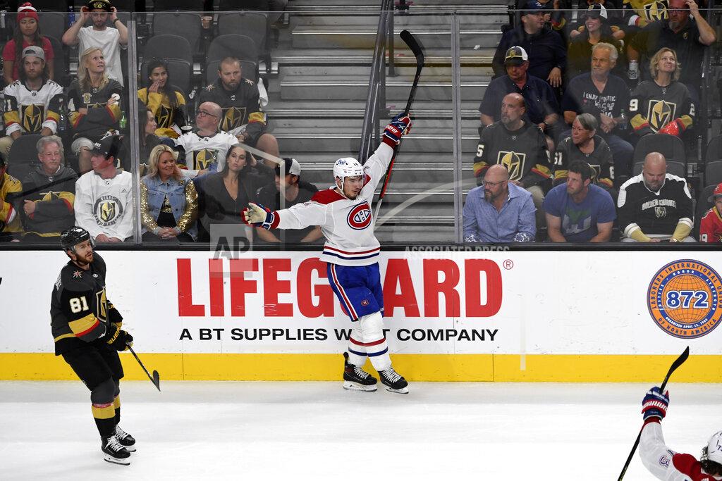 David Becker Montreal Canadiens center Nick Suzuki (14) celebrates his empty net goal as Vegas Golden Knights center Jonathan Marchessault (81) skates by during the third period in Game 5 of an NHL hockey Stanley Cup semifinal playoff series Tuesday, June 22, 2021, in Las Vegas. (AP Photo/David Becker)