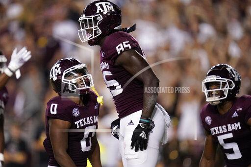 Texas A&M tight end Jalen Wydermyer (85) smiles with teammates Ainias Smith (0) and Jalen Preston (5) after scoring a 25-yard touchdown against South Carolina during the first quarter of an NCAA college football game on Saturday, Oct. 23, 2021, in College Station, Texas. (AP Photo/Sam Craft)