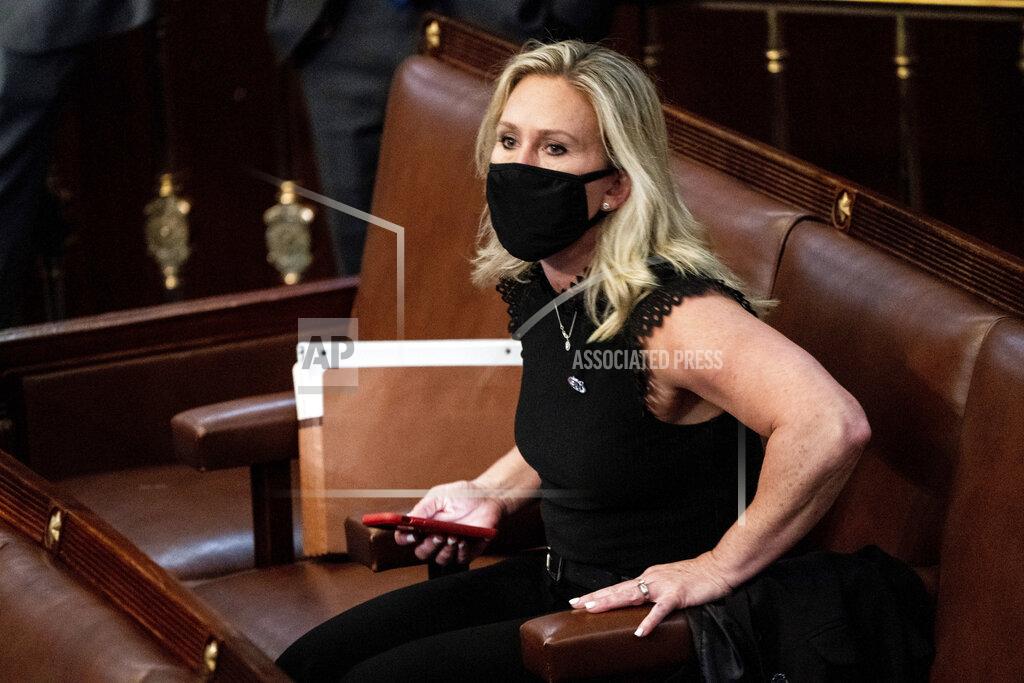 Erin Schaff FILE - In this Jan. 6, 2021, file photo, Rep. Marjorie Taylor Greene, R-Ga., sits in the House Chamber after they reconvened for arguments over the objection of certifying Arizona's Electoral College votes in November's election, at the Capitol in Washington. Republicans have a Marjorie Taylor Greene problem. Again. Before she joined Congress this month, Greene supported Facebook posts that advocated violence against leading Democrats and the FBI. While some Republicans condemned the activity on Wednesday, it was hardly a surprise. Facebook posts surfaced last year showing she’d expressed racist, anti-Semitic and anti-Muslim views. (Erin Schaff/The New York Times via AP, Pool, File)