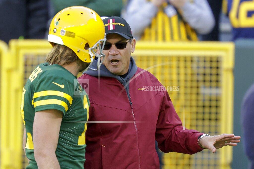 Matt Ludtke Washington Football Team head coach Ron Rivera talks to Green Bay Packers' Aaron Rodgers before an NFL football game Sunday, Oct. 24, 2021, in Green Bay, Wis. (AP Photo/Matt Ludtke)