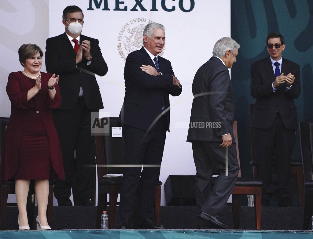 Marco Ugarte Cuba's first lady Lis Cuesta, left, and Mexico's Foreign Minister Marcelo Ebrard applaud Cuba's President Miguel Diaz-Canel, center, as he acknowledges the crowd and Mexico's President Andres Manuel Lopez Obrador returns to his seat, during Independence Day celebrations in the Zocalo in Mexico City, Thursday, Sept. 16, 2021. (AP Photo/Marco Ugarte)