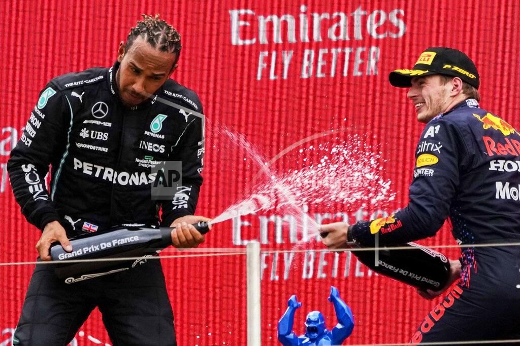 Francois Mori Red Bull driver Max Verstappen of the Netherlands, right, celebrates from the podium after winning with second place Mercedes driver Lewis Hamilton of Britain from the podium during the French Formula One Grand Prix at the Paul Ricard racetrack in Le Castellet, southern France, Sunday, June 20, 2021. (AP Photo/Francois Mori)