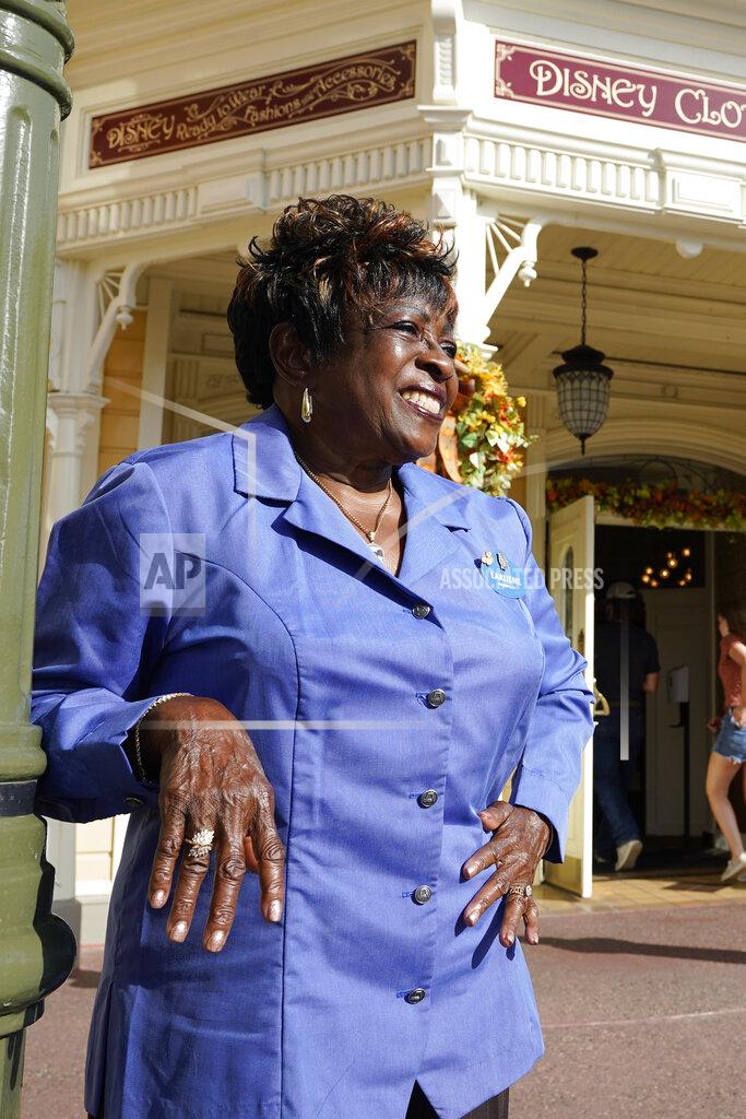 John Raoux 50 year employee Earliene Anderson stands on Main Street at the Magic Kingdom theme park at Walt Disney World Monday, Aug. 30, 2021, in Lake Buena Vista, Fla. "Disney has been my love, and it still is," Anderson said recently before starting her shift in merchandising. (AP Photo/John Raoux)