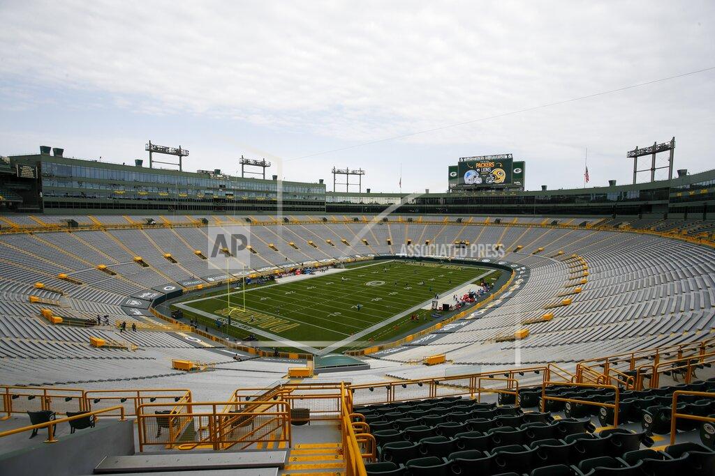 Matt Ludtke Players begin to warm up as the seats are empty at Lambeau Field before an NFL football game between the Green Bay Packers and the Detroit Lions Sunday, Sept. 20, 2020, in Green Bay, Wis. (AP Photo/Matt Ludtke)
