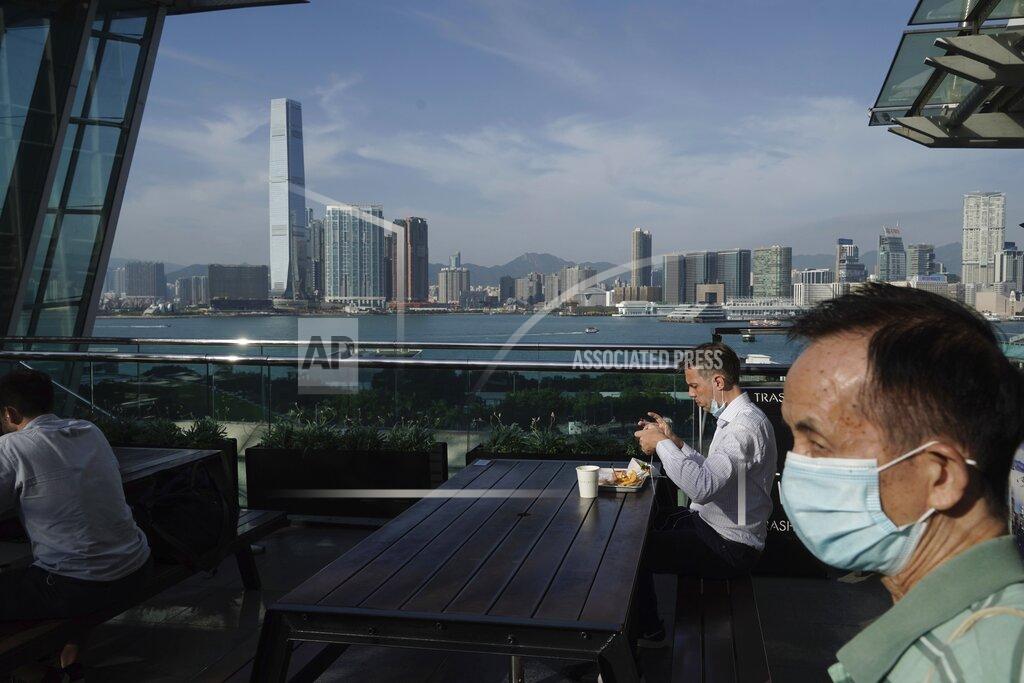 Kin Cheung A man eats in a restaurant at waterfront in Hong Kong, Thursday, Oct. 15, 2020. Hong Kong and Singapore say they have agreed to a bilateral air travel bubble, re-establishing travel links as coronavirus infections in both cities decline. (AP Photo/Kin Cheung)