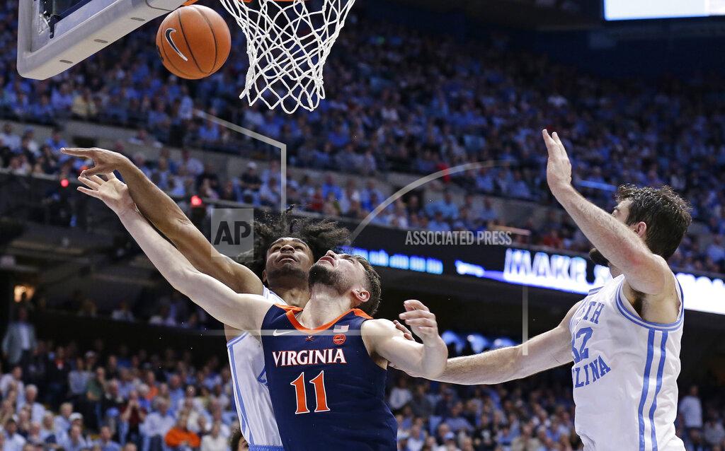 Gerry Broome North Carolina's Coby White, left, and Luke Maye guard while Virginia's Ty Jerome (11) shoots during the second half of an NCAA college basketball game in Chapel Hill, N.C., Monday, Feb. 11, 2019. (AP Photo/Gerry Broome)