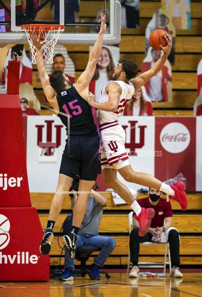 Doug Mcschooler Indiana forward Race Thompson (25) is defended by Penn State forward Trent Buttrick (15) as he tries to score with a slam dunk during the first half of an NCAA college basketball game, Wednesday, Dec. 30, 2020, in Bloomington, Ind. (AP Photo/Doug McSchooler)