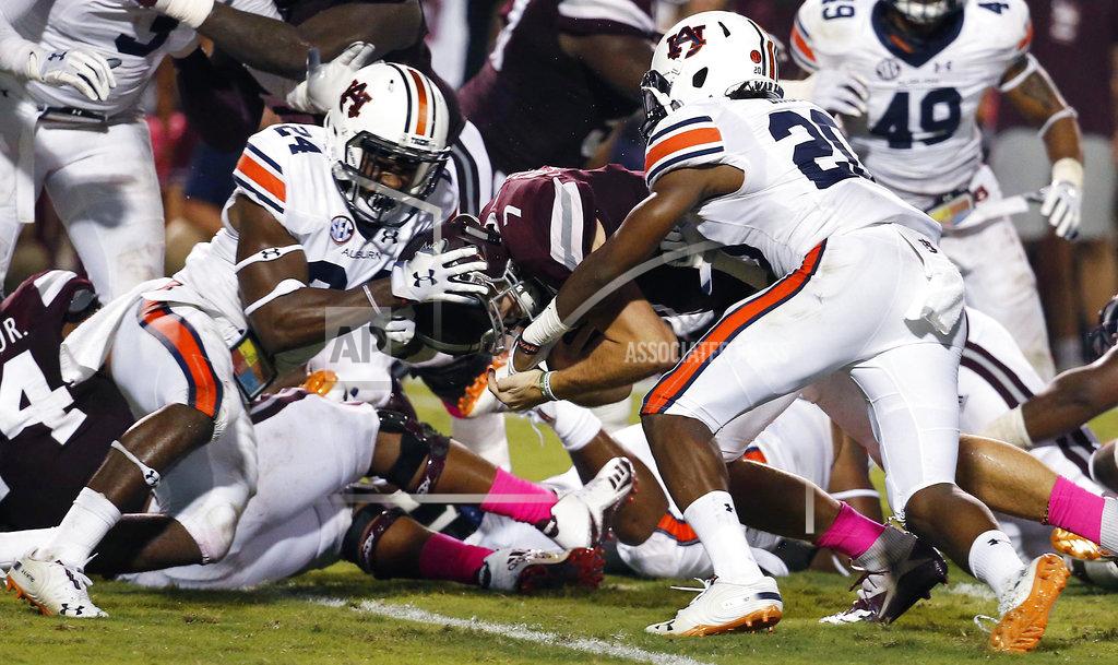 Rogelio V. Solis Auburn defensive backs Daniel Thomas (24) and Jeremiah Dinson (20) fail from keeping Mississippi State quarterback Nick Fitzgerald (7) from scoring on a one-yard dive into the end zone during the first half of their NCAA college football game in Starkville, Miss., Saturday, Oct. 6 2018. (AP Photo/Rogelio V. Solis)