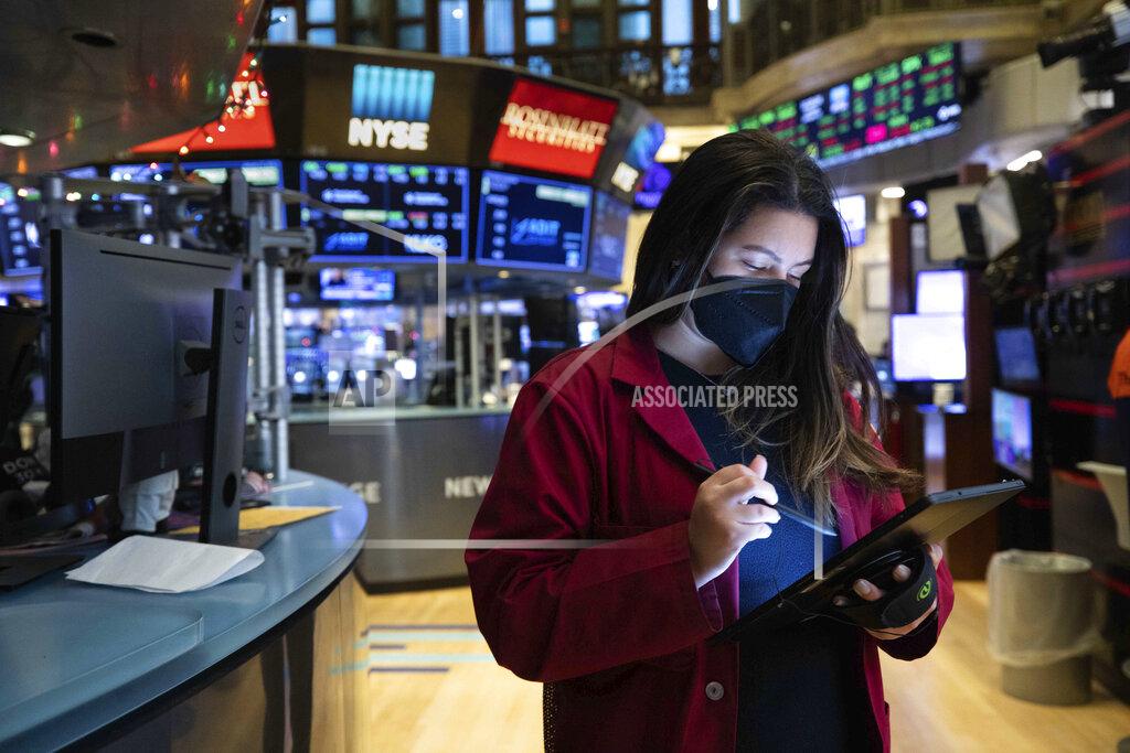 Colin Ziemer In this photo provided by the New York Stock Exchange, trader Ashley Lara works on the trading floor, Tuesday, Jan. 12, 2021. U.S. stocks are drifting near their record heights Tuesday, while Treasury yields keep marching higher amid expectations that the economy will pull out of its slump after a powerful recovery sweeps the globe later this year. (Colin Ziemer/New York Stock Exchange via AP)