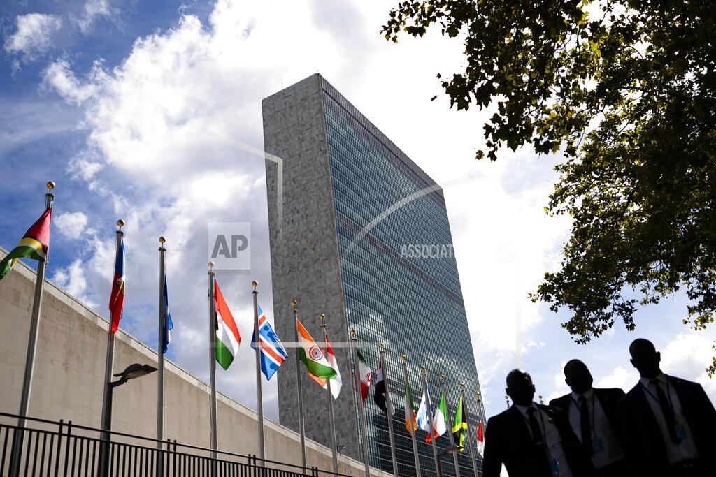 John Minchillo Members of a delegation's entourage wait outside a security checkpoint on the sidewalk in front of the United Nations headquarters, Tuesday, Sept. 21, 2021, during the 76th Session of the U.N. General Assembly in New York. (AP Photo/John Minchillo, Pool)