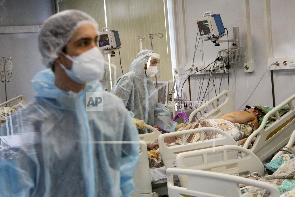 Roman Yarovitcyn Medical staff in special suits treat a COVID-19 patient at an ICU in Infectious Hospital No. 23 in Nizhny Novgorod, Russia, on Wednesday, Oct. 20, 2021. Russians’ hesitancy in getting the vaccine is of increasing concern as the country suffers a sharp rise in cases, setting records for infections and deaths nearly every day this month. (AP Photo/Roman Yarovitcyn)