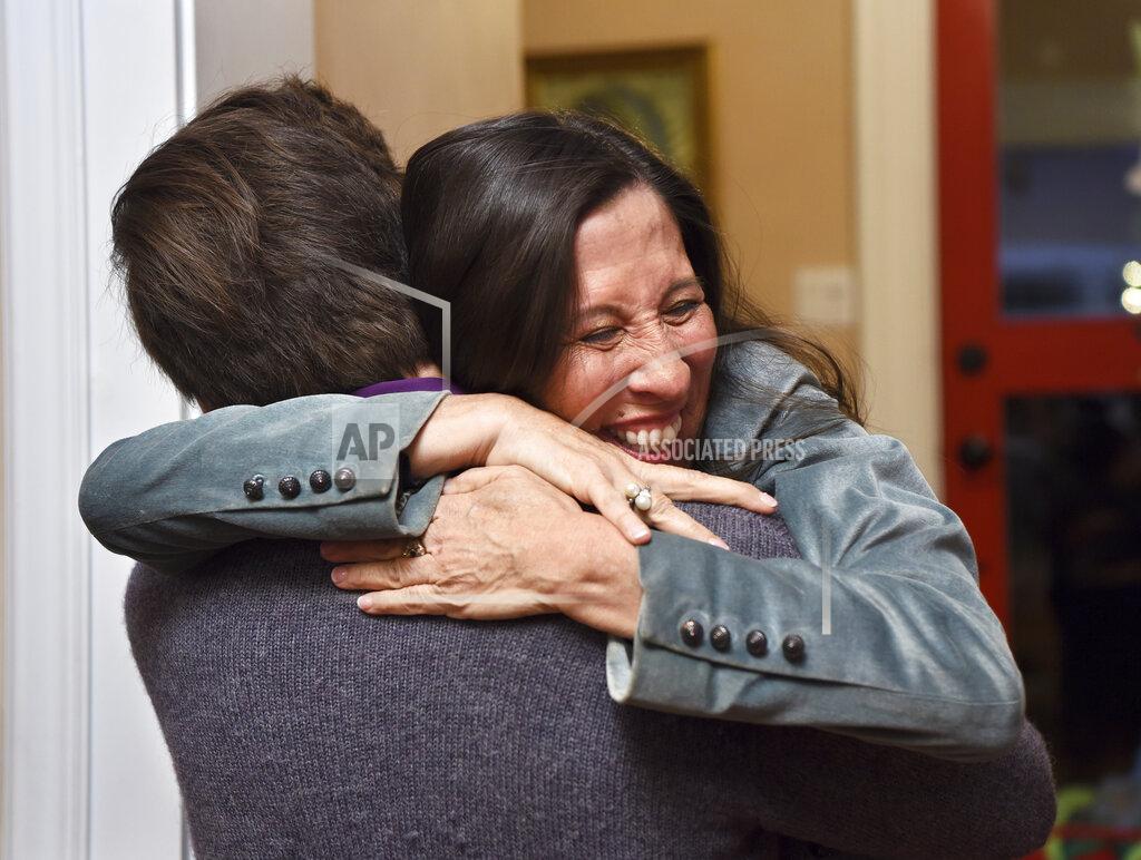 Eddie Moore Teresa Leger Fernandez hugs her son Dario Fernandez-Leger at her home in Santa Fe, N.M., Tuesday, Nov. 3, 2020, after hearing she has been declared the winner of New Mexico Congressional District 3. (Eddie Moore/The Albuquerque Journal via AP)