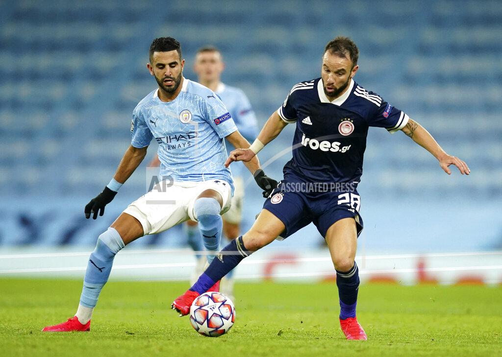 Dave Thompson Manchester City's Riyad Mahrez, left, duels for the ball with Olympiacos' Mathieu Valbuena during the Champions League group C soccer match between Manchester City and Olympiacos at the Etihad stadium in Manchester, England, Tuesday, Nov. 3, 2020. (AP Photo/Dave Thompson)