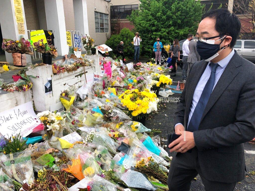 Sudhin Thanawala New Jersey Rep. Andy Kim looks over flowers and messages at a memorial for the victims of the March 16 shootings in front of Gold Spa, one of the shooting sites on Sunday, March 28, 2021 in Atlanta. (AP Photo/Sudhin Thanawala)